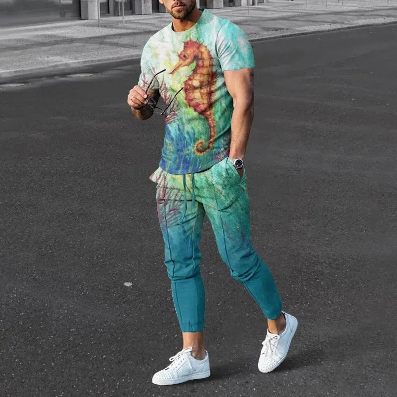 Man wearing a light grey short-sleeved pullover and matching trousers from a men's two-piece tracksuit set.