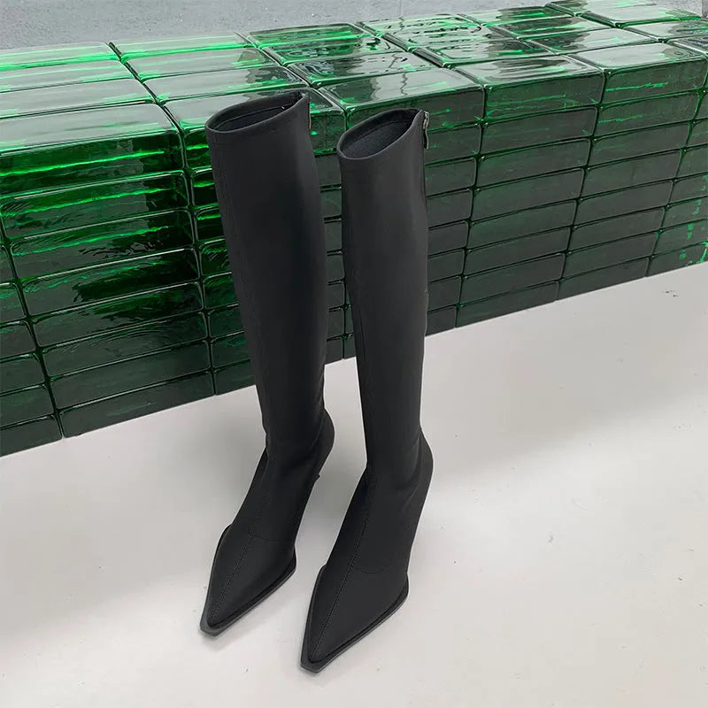 Black pointed toe stiletto heel boots with a back zipper, showing the below-the-knee shaft height.