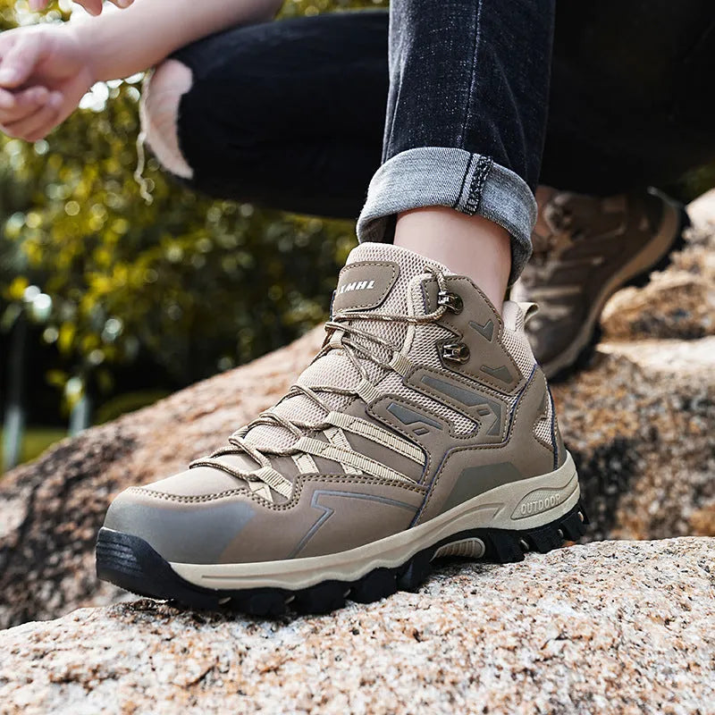 Flannel upper hiking sneakers with rubber soles in light brown colour on a rocky path.