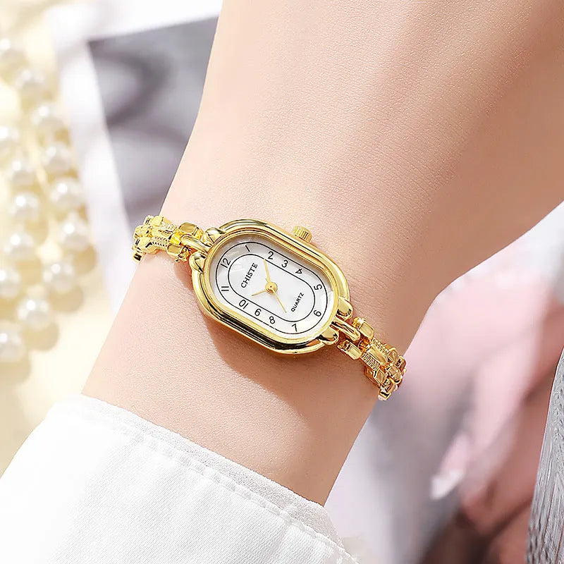 Retro oval women's quartz bracelet watch with metal strap and gold-tone dial