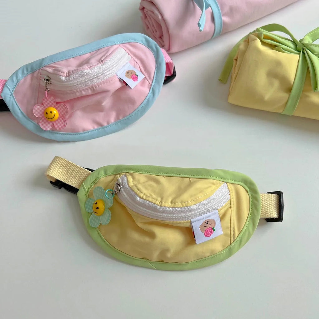 Pink and yellow backpack-style carrier bag for a small dog or cat on a person's back.
