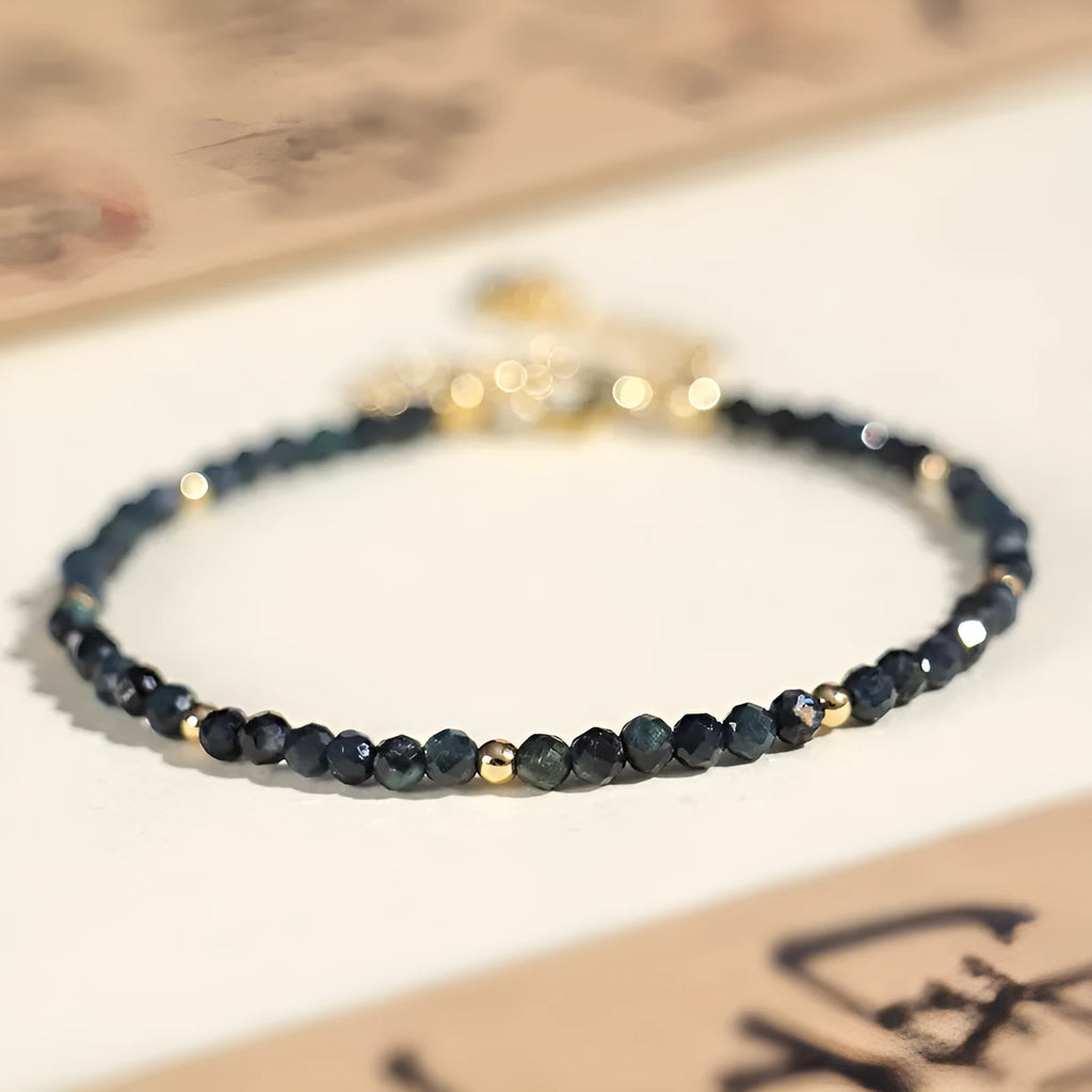 Close-up of a women's blue tourmaline bracelet with 3mm cut beads and spacer bead design.