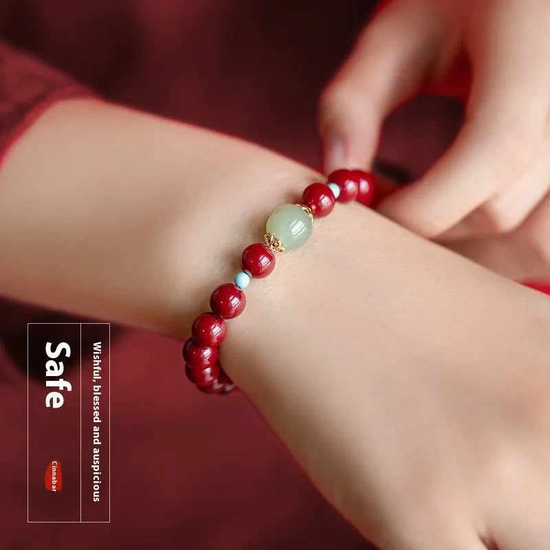 Purple Gold Sand cinnabar Hetian jade bead bracelet in geometric elliptical shape on wrist.
