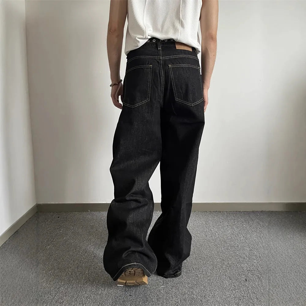 Black retro straight-leg jeans with wide-leg design on hanger