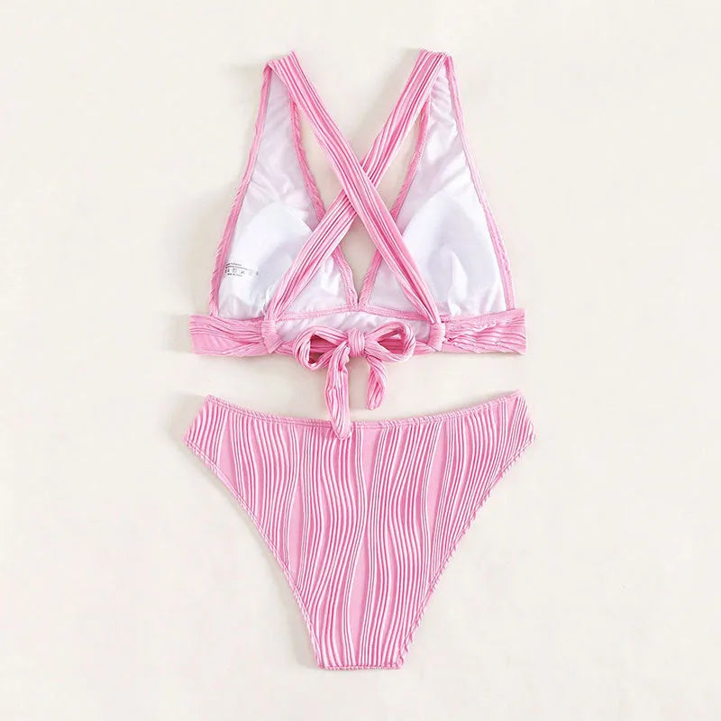 Women's halter strap split swimsuit bikini set in black with shorts and top on white background