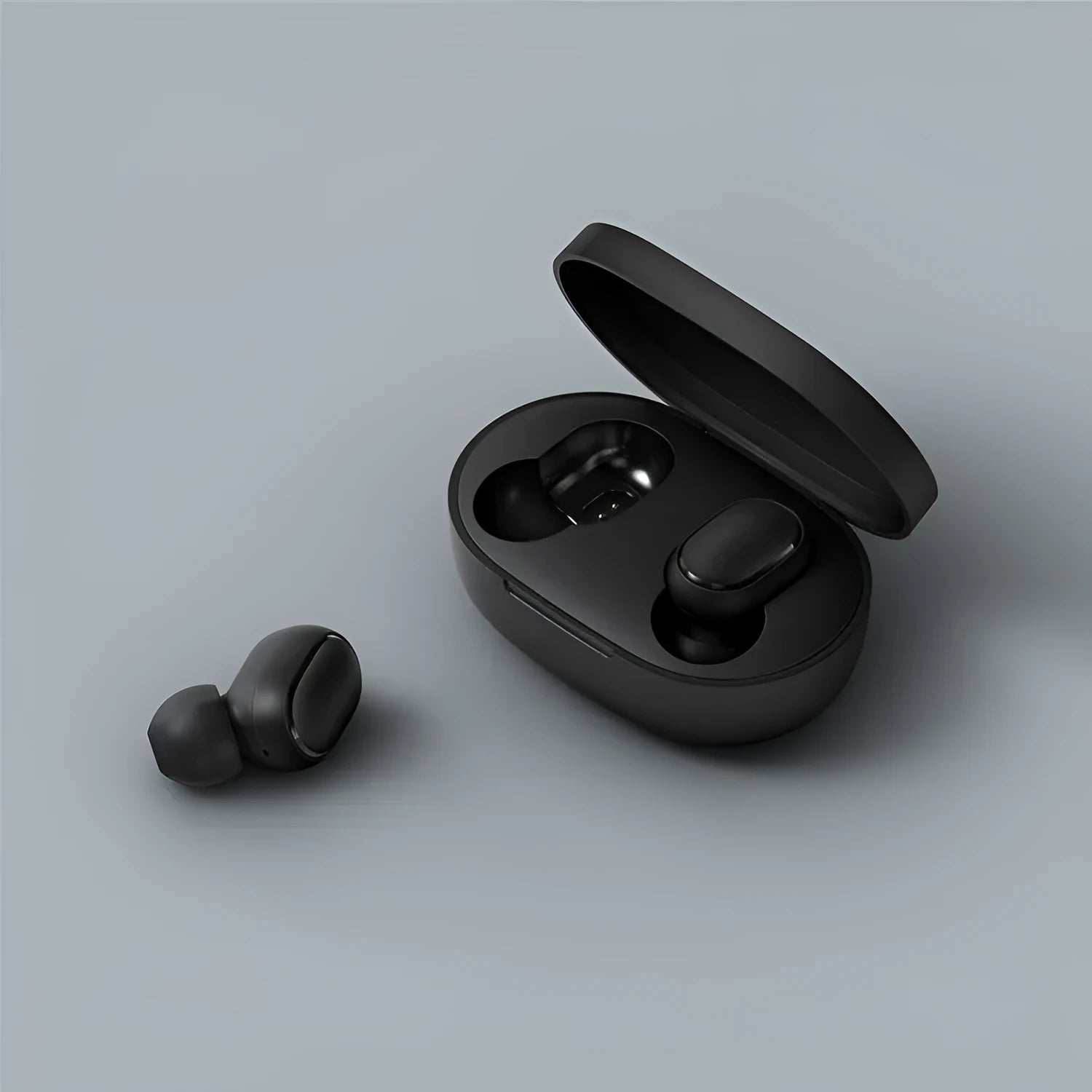 Redmi AirDots black true wireless earbuds and their compact charging case on a white background.
