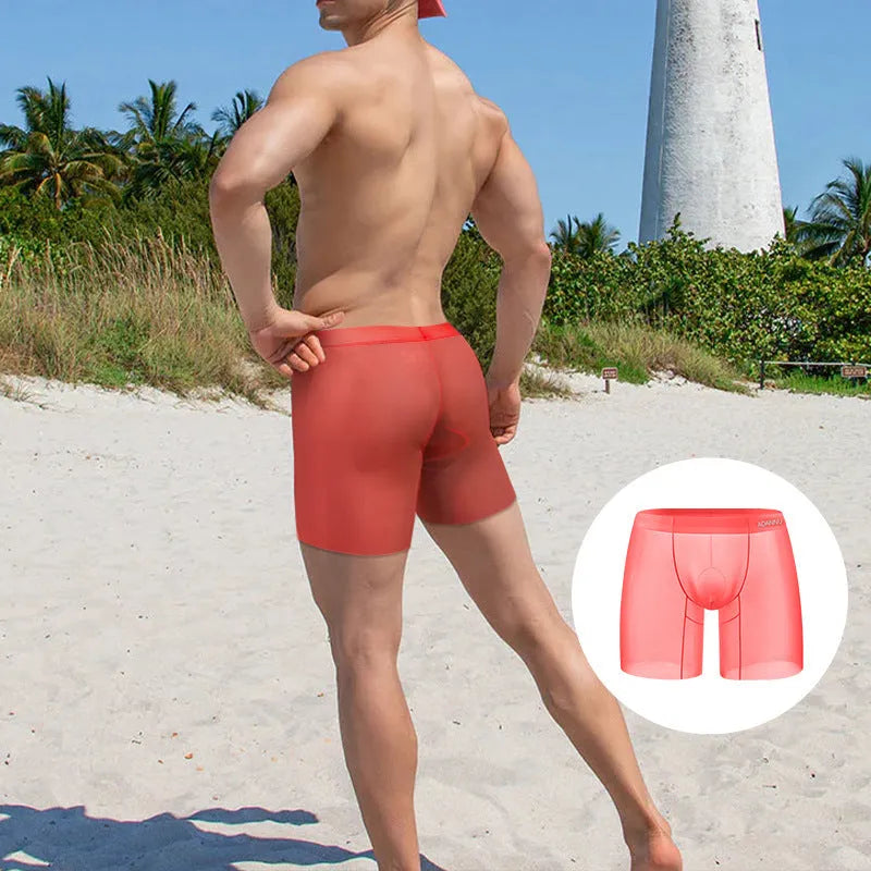 A pair of solid colour men's ice silk boxer shorts with a low waist design, shown in orange.