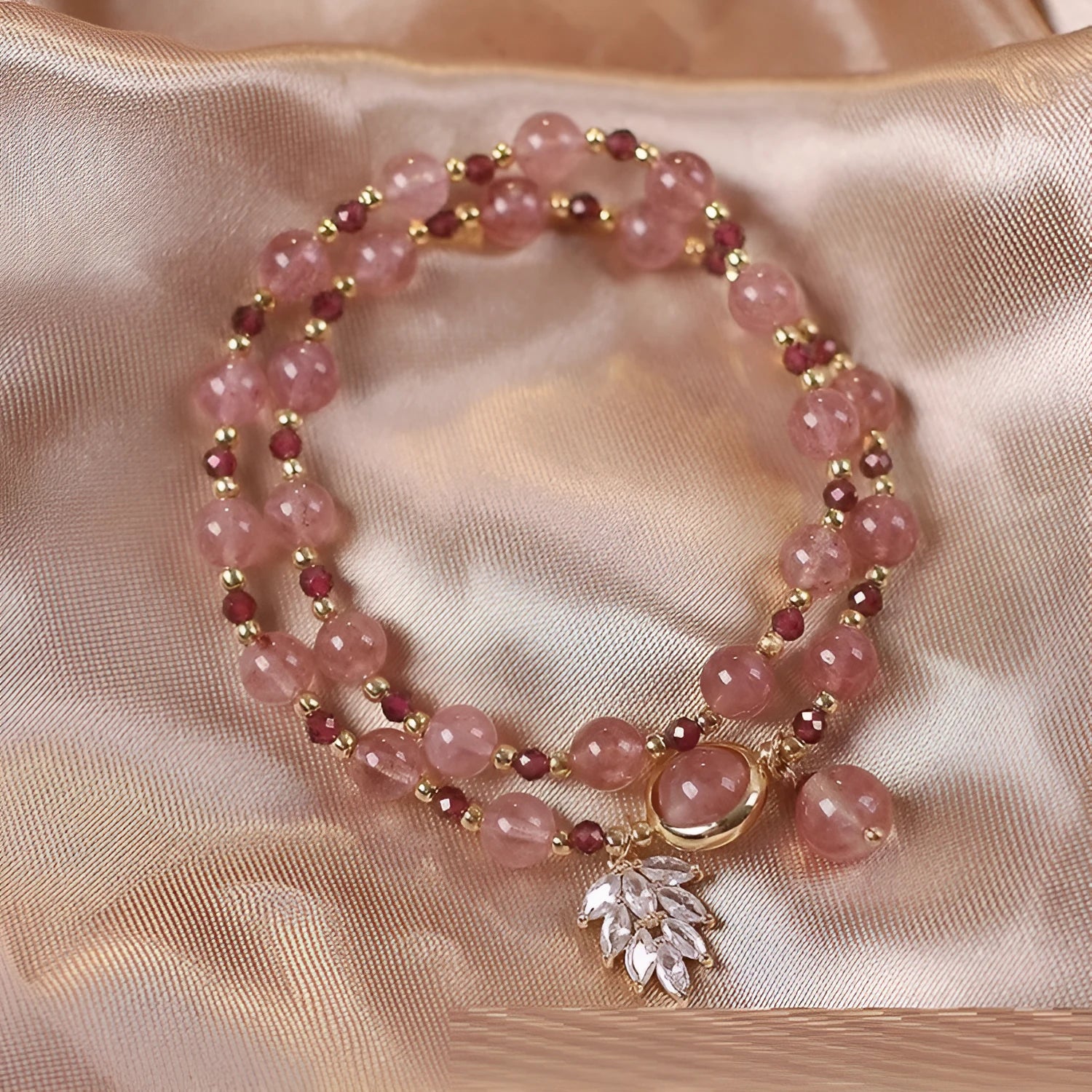 Women's double circle crystal bracelet with flower-shaped crystal detail in Strawberry Quartz colour