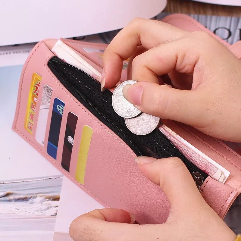 Women's long tri-fold wallet in light grey PU leather with sewing thread detail, open to show multiple card slots and cash compartments.