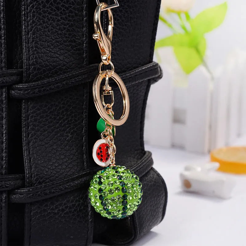 Green zinc alloy keychain shaped like a watermelon, measuring 12cm in length.