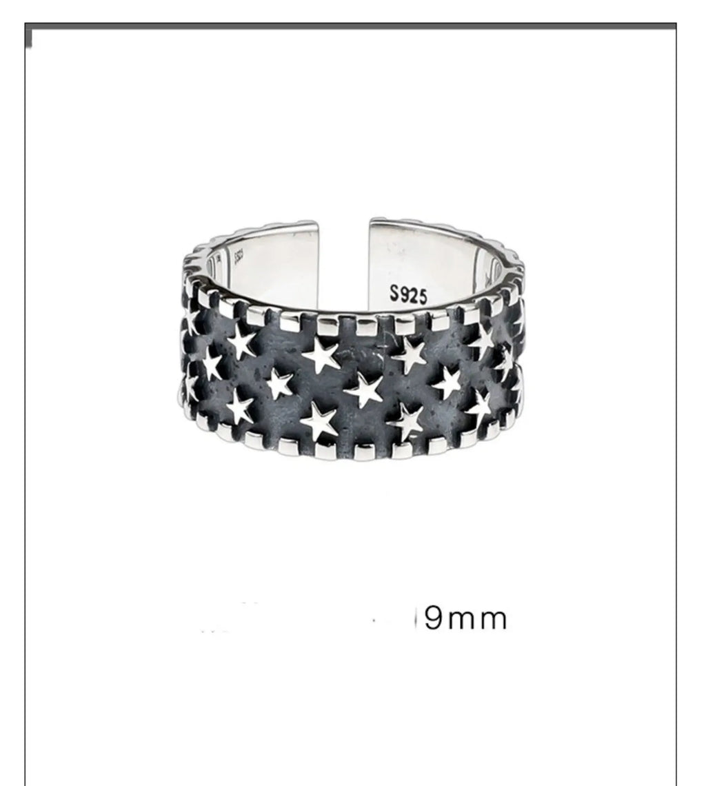 Adjustable open band sterling silver ring with a geometric five-pointed star design.