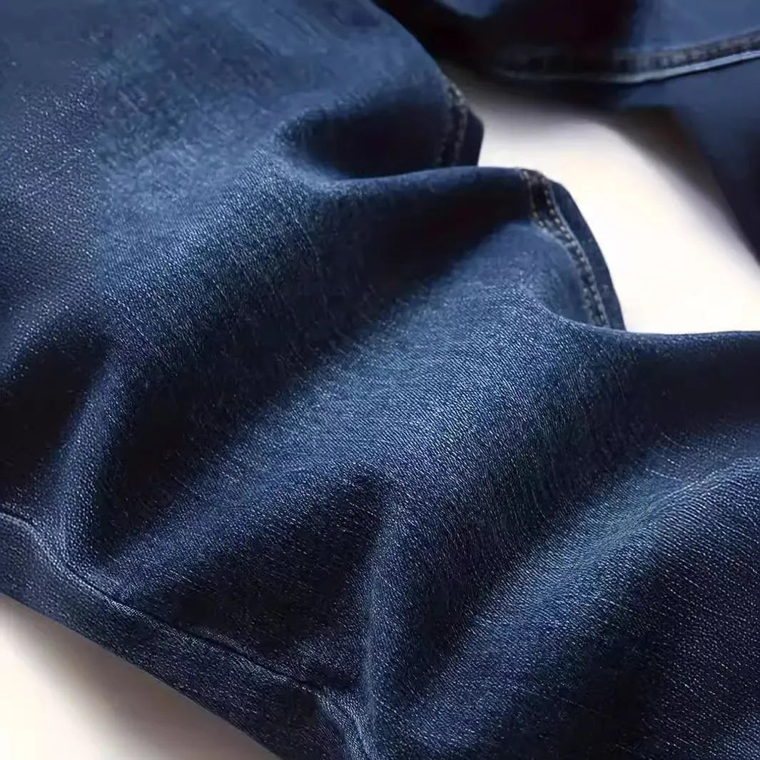Dark blue men's slim fit cotton jeans with a skinny leg opening on a mannequin