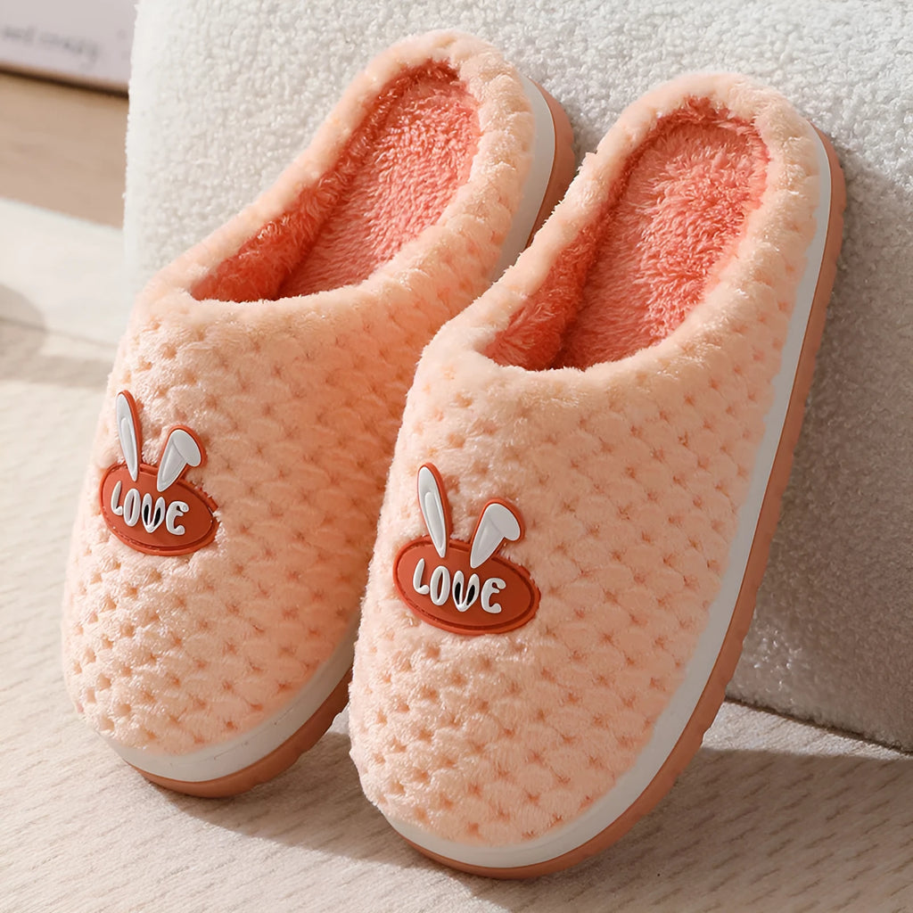 Women's rabbit plaid design artificial fur house slippers with a thick non-slip rubber sole.