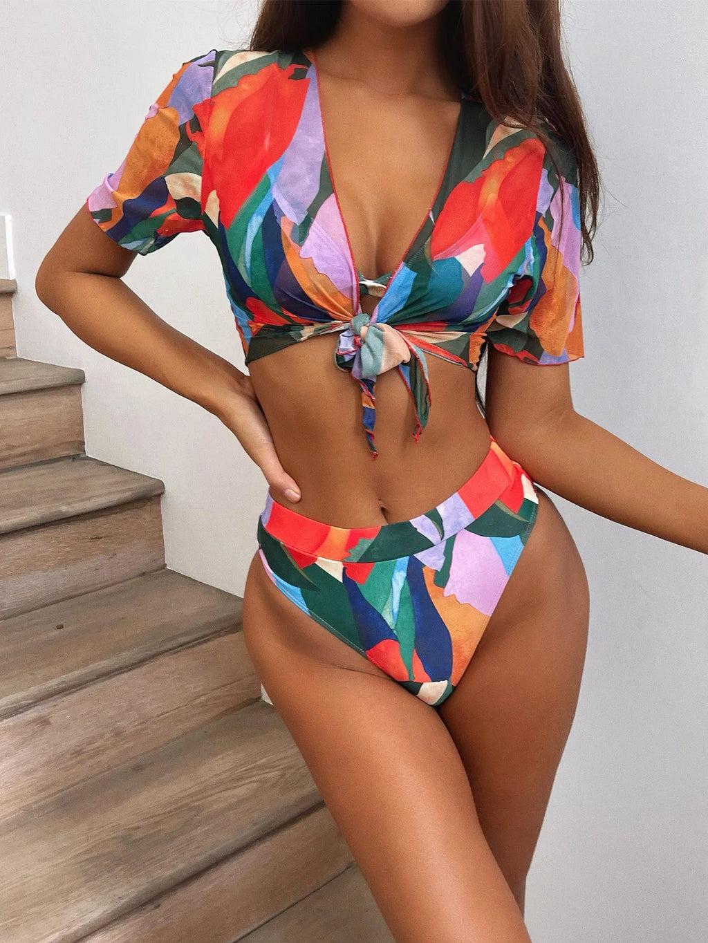 Red printed women's split swimsuit in nylon fabric for swimming.