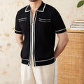 Slim-fit black lapel polo shirt with short sleeves on a hanger, showing elastic knitted texture.