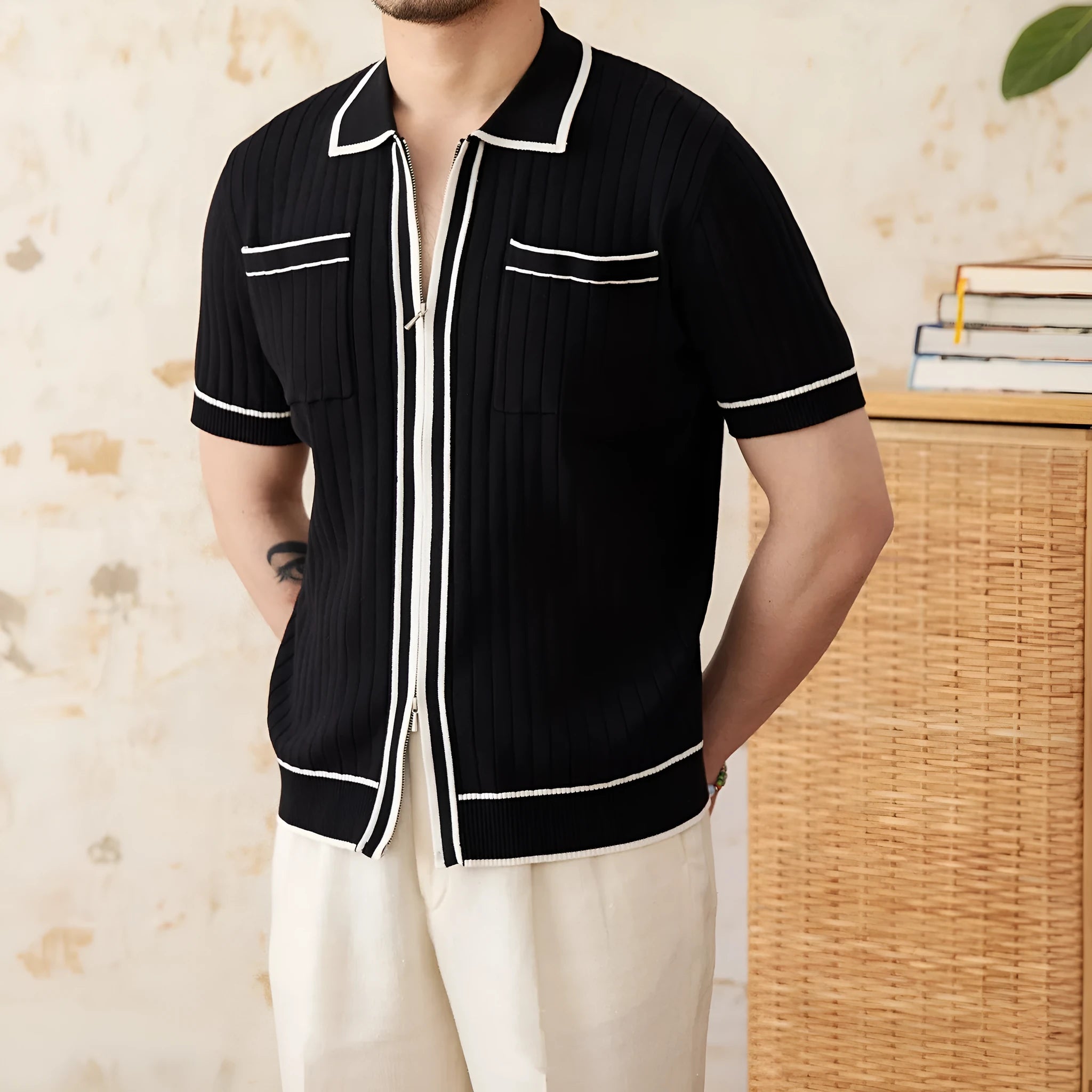 Slim-fit black lapel polo shirt with short sleeves on a hanger, showing elastic knitted texture.