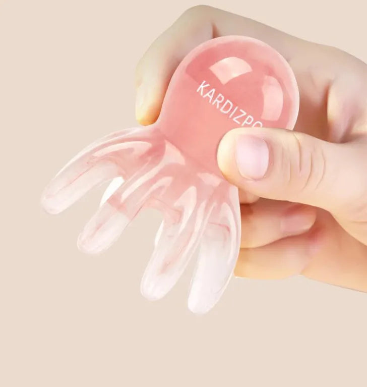 Pink octopus-shaped natural resin massage comb for periocular meridian, shown with its storage bag.