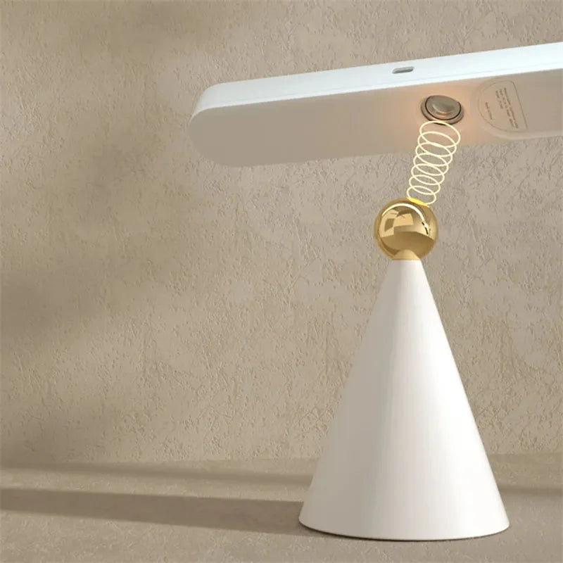 Geometric creative desk lamp with magnetic base shown in white on a desk.