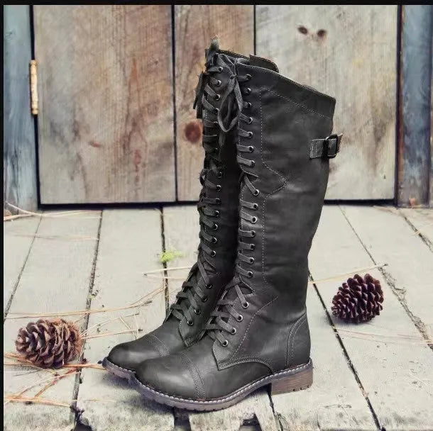 Women's black chunky heel high-leg casual boots with a round toe and rubber sole.