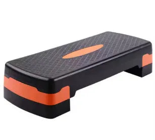Grey fit step aerobic platform for yoga and fitness exercises on wooden floor