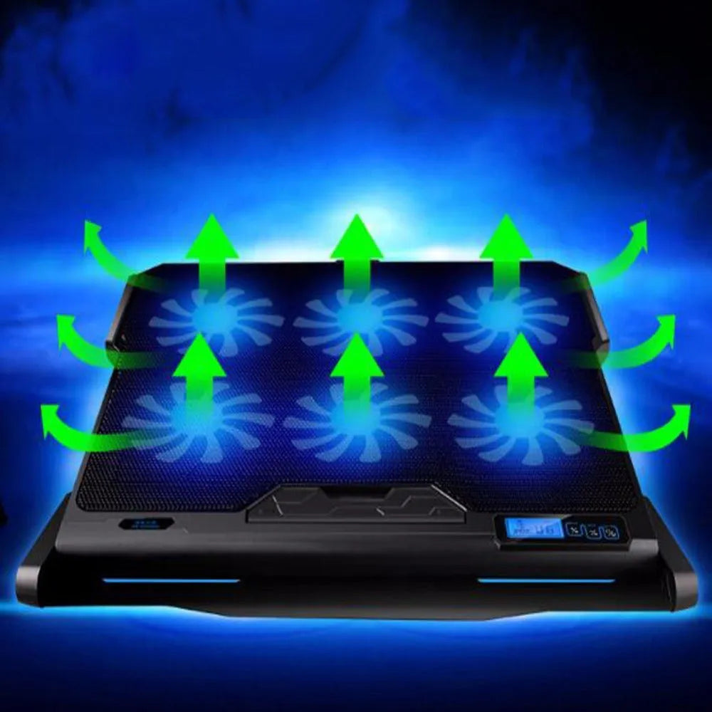 Black metal mesh laptop cooling board with USB cable on a desk next to a notebook.