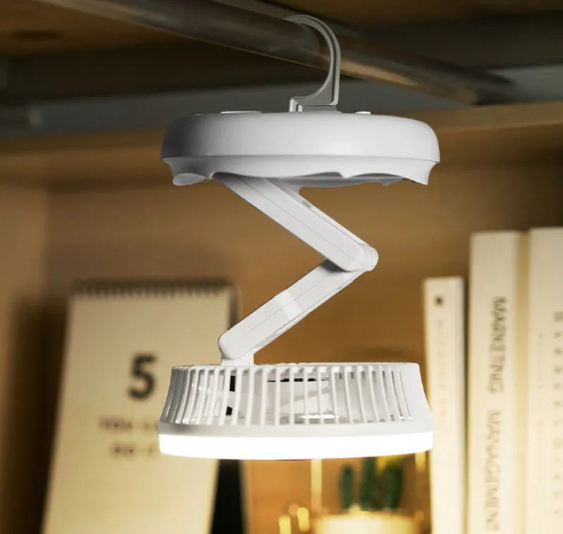 USB charging foldable table fan with LED light and 300-degree rotation on a desk
