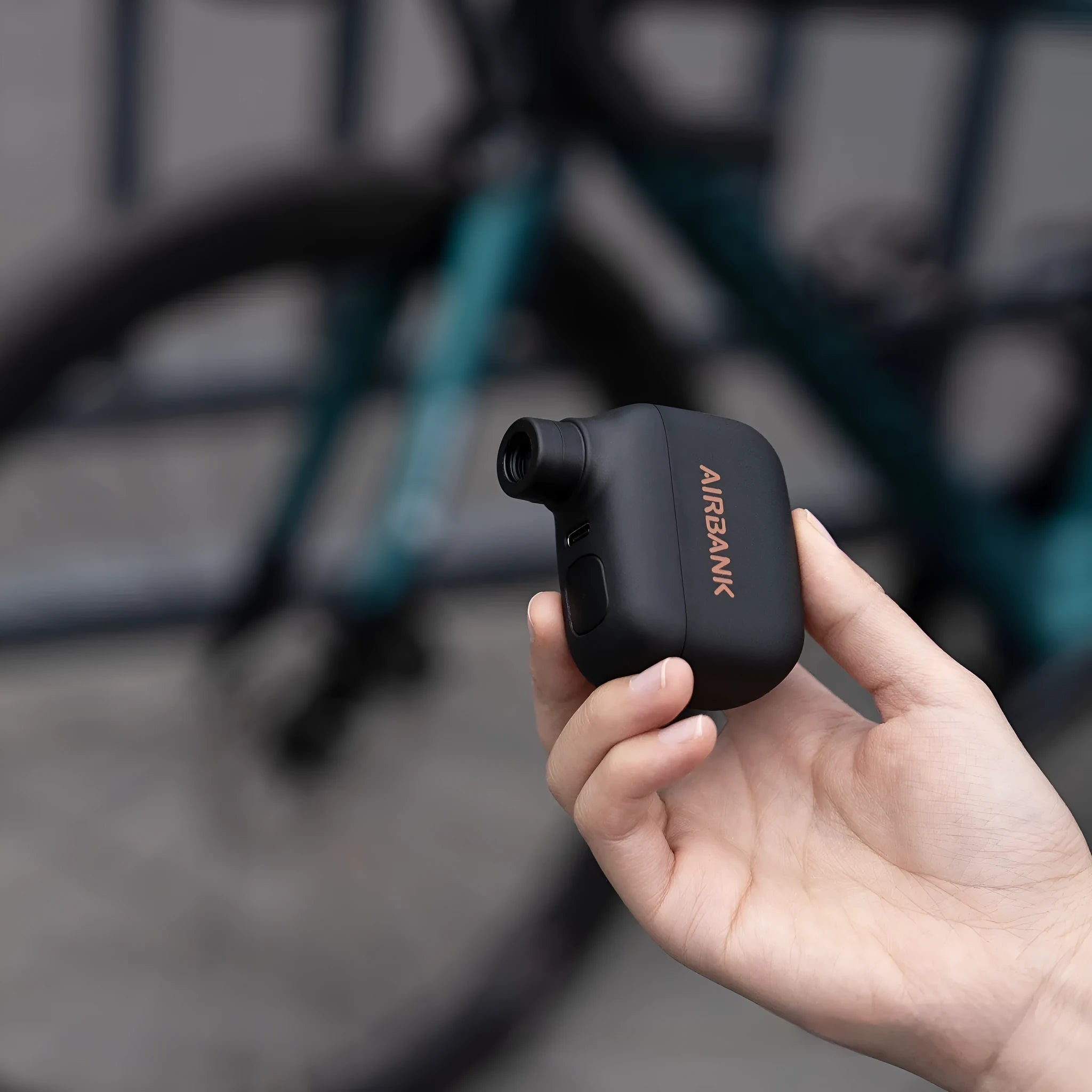 Black AS100 mini electric bike tyre pump with USB charging cable and waterproof storage bag