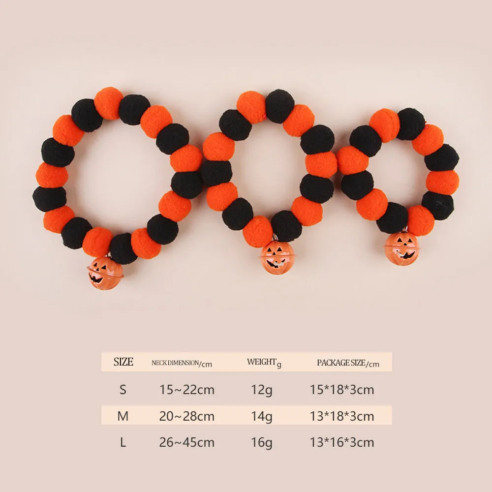 Orange Halloween pumpkin dog cat collar with green ribbon leaf, black stripes, jingle bell, and breakaway buckle on grey background.