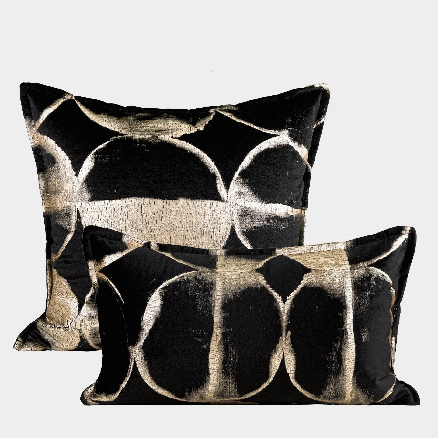 Black gold abstract patterned flannel decorative cushion on a sofa.