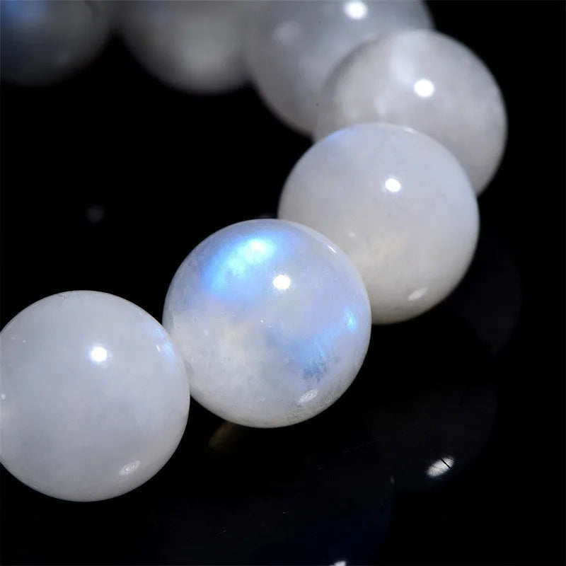 Natural blue moonstone round bead bracelet with white accents showing polished stone surface