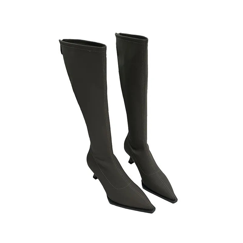 Black pointed toe stiletto heel boots with a back zipper, showing the below-the-knee shaft height.