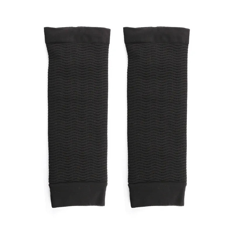Women's nylon arm sleeves in black and skin tone colours showing shaping compression design