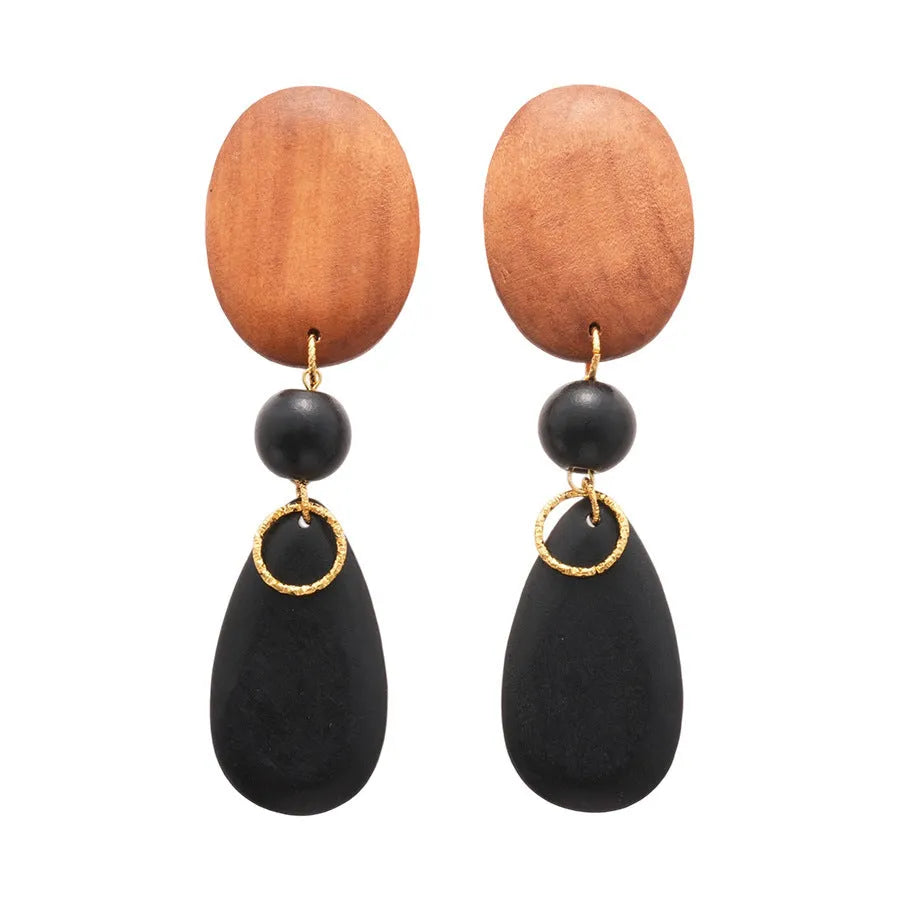A pair of handcrafted wooden earrings with an elliptical shape in a silver, brown, and black colour finish.