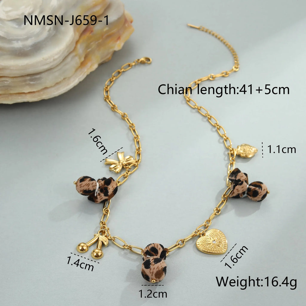 Stainless steel necklace with geometric pendant showing leopard spots, love hearts and flowers in gold finish