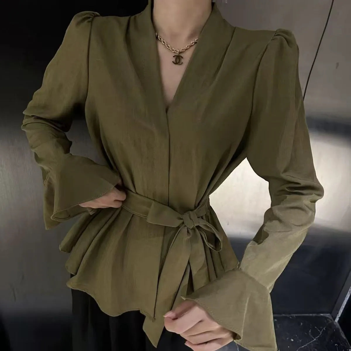 Women's French-style shirt with irregular collar, long bell sleeves, and tie-front closure in black colour