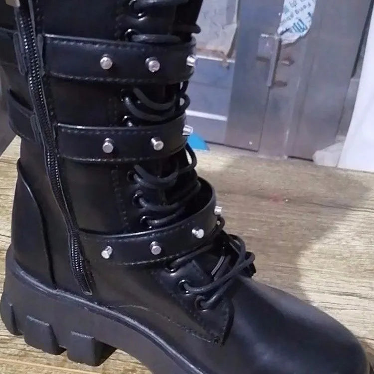 Black mid-calf women's boots with a prominent buckle detail and side zipper on a white background.