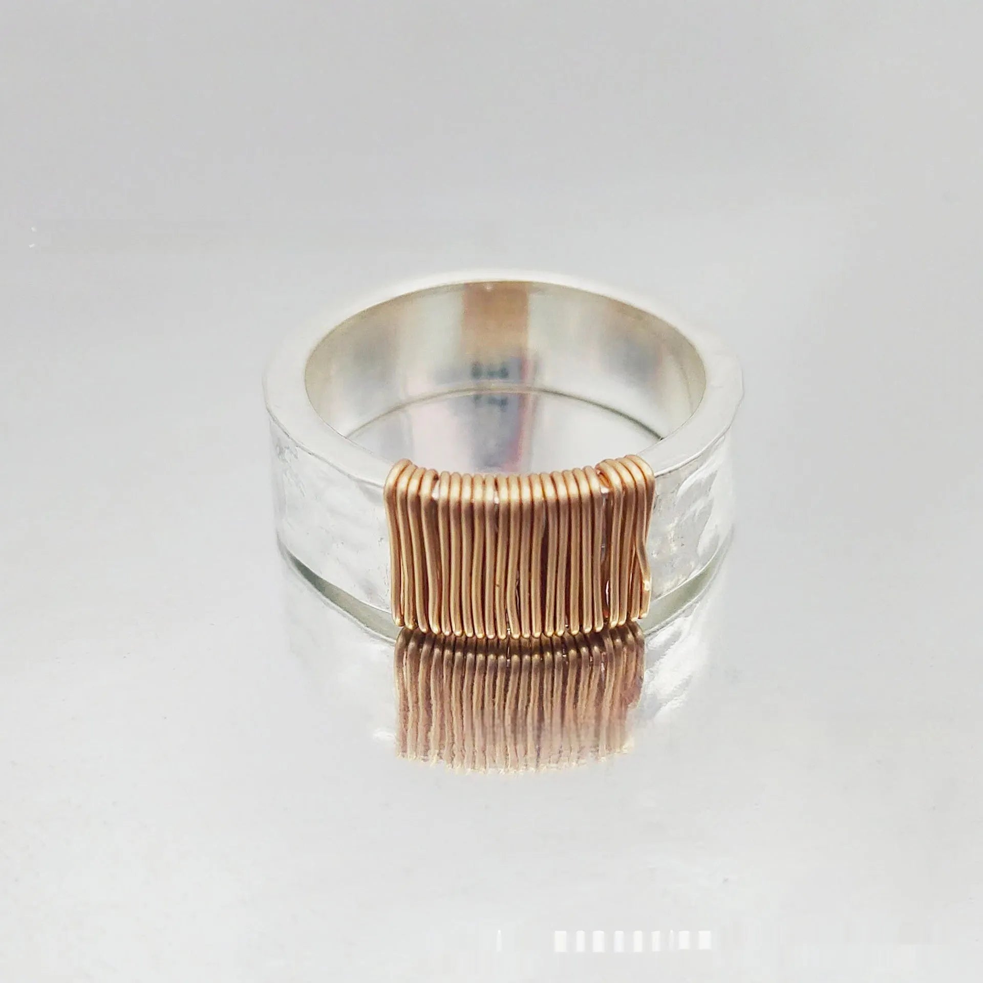 Copper geometric bracelet with irregular coil design in electroplated silver gold colour