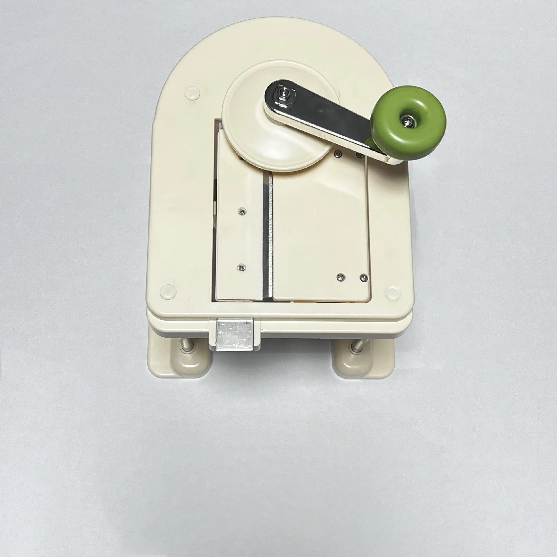 Beige multifunctional vegetable slicer chopper with stainless steel blades on a kitchen counter