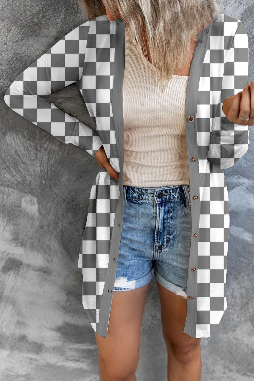 Women's long grey plaid knitted cardigan coat with a loose fit on a hanger.