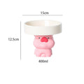 Raised ceramic cat bowl with animal design in pink, yellow, or white, showing wide feeding surface and elevated base.