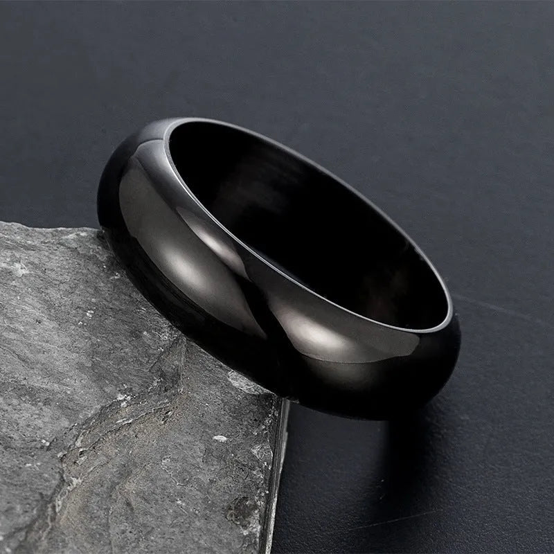 Glossy electroplated titanium steel ring shown in gold, black, and steel colour on a size chart