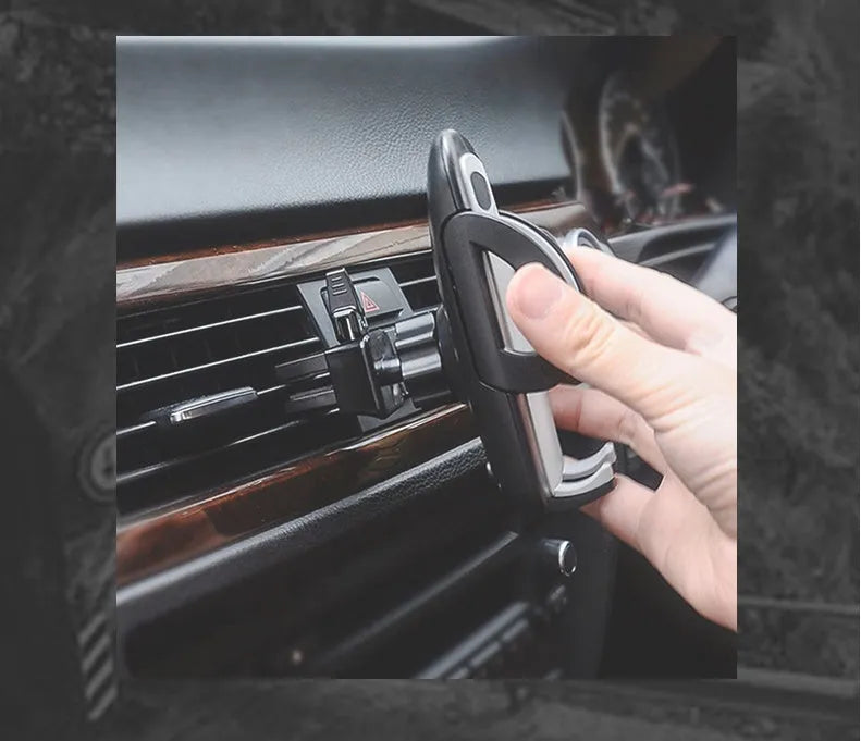 Black car air vent mobile phone holder mounted on vehicle air conditioning outlet holding smartphone
