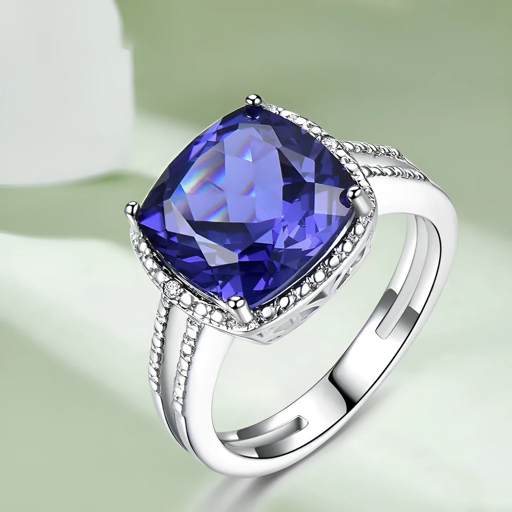 Blue Tanzanite gemstone sterling silver ring on white background showing band detail