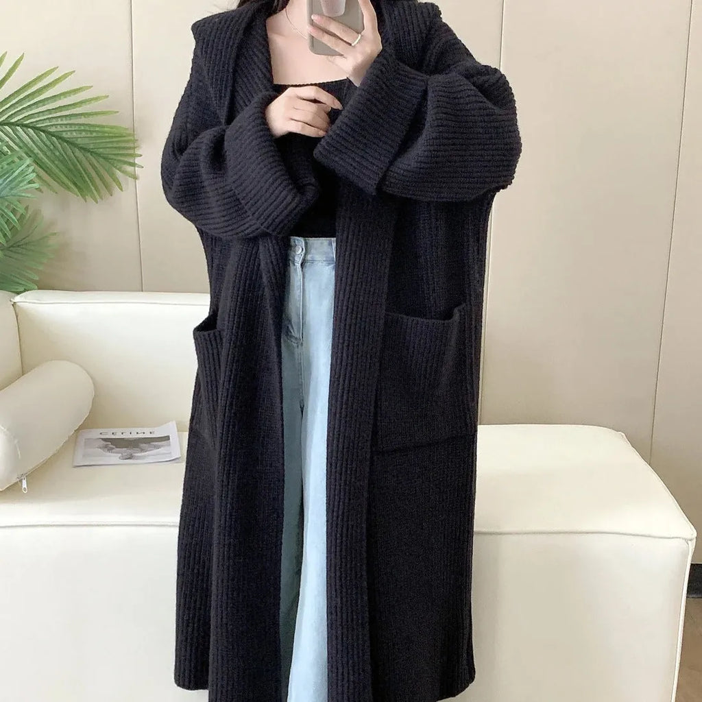 Women's loose hooded cardigan coat in acrylic fabric with raglan sleeves showing front opening