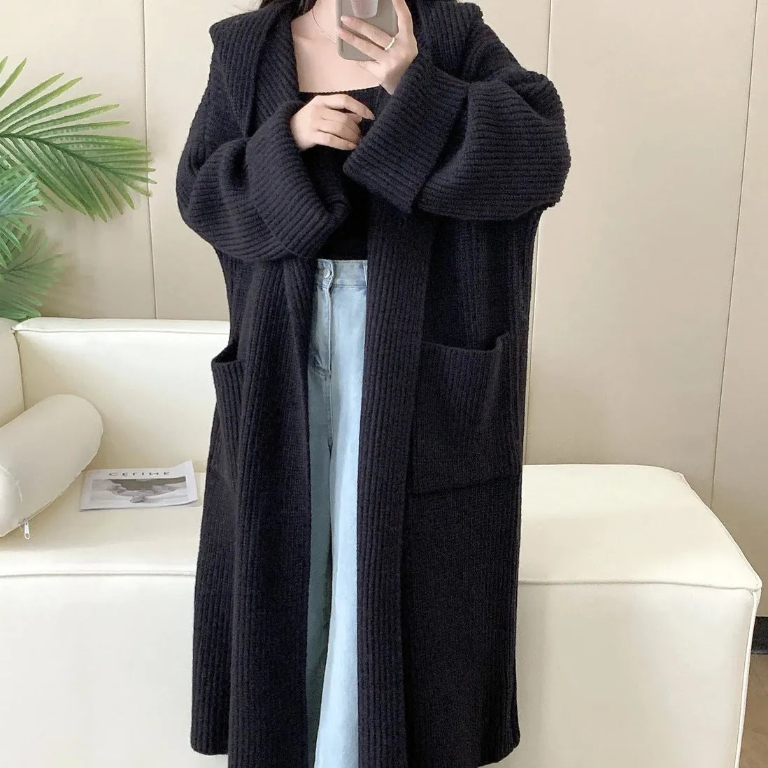 Women's loose hooded cardigan coat in acrylic fabric with raglan sleeves showing front opening