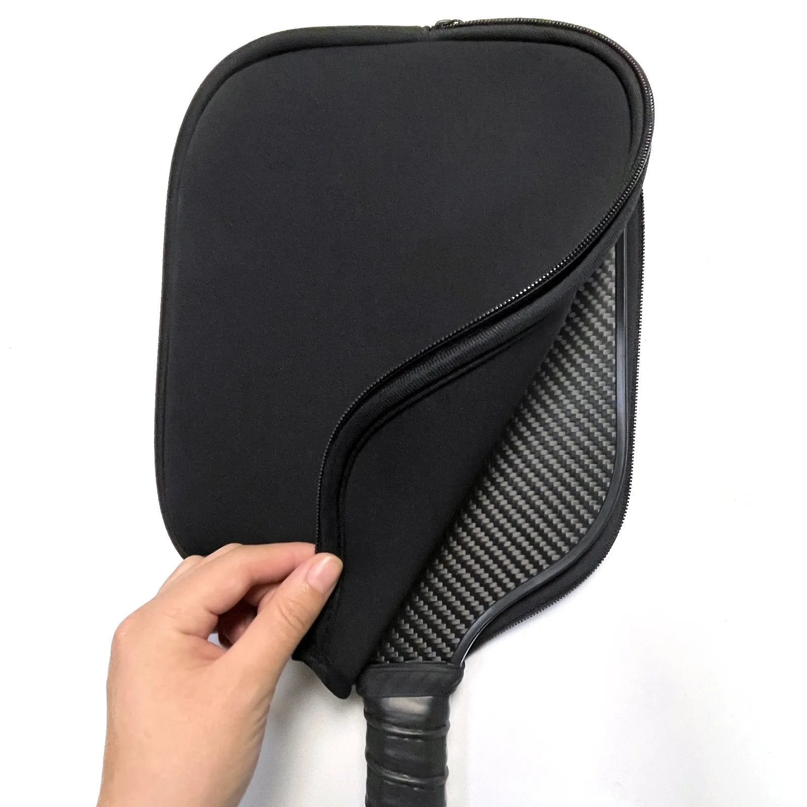 Black neoprene protective sleeve for table tennis racket, laid flat on surface