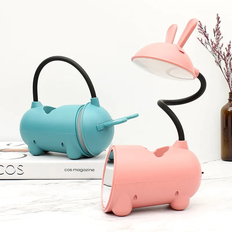 Cartoon-themed USB table lamp with pen container in green colour on desk