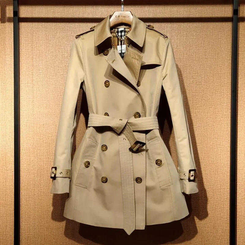 Khaki double-breasted trench coat for women with flight sleeves and button fastening.