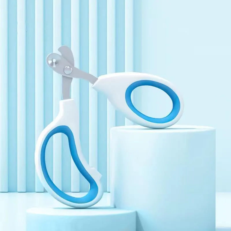 Blue pet nail clippers with circular hole design and cushioned non-slip handle on a white background.