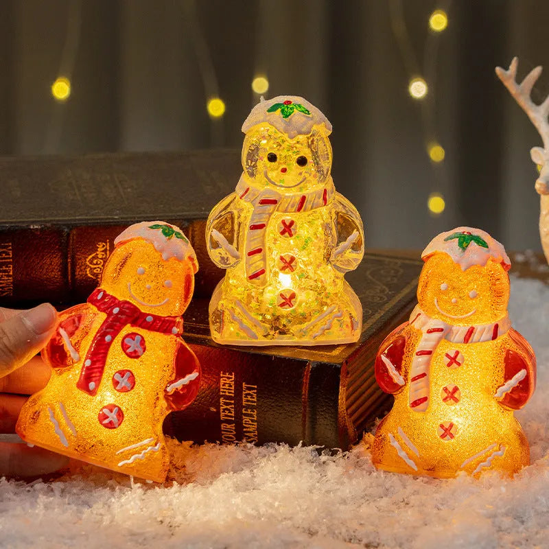 Glowing LED gingerbread man snowman Christmas ornament with a red scarf on a festive tree.